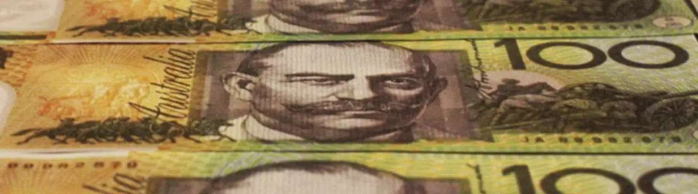 Stack of cash and coins symbolizing funding or investment in construction site safety and barrier installation projects.