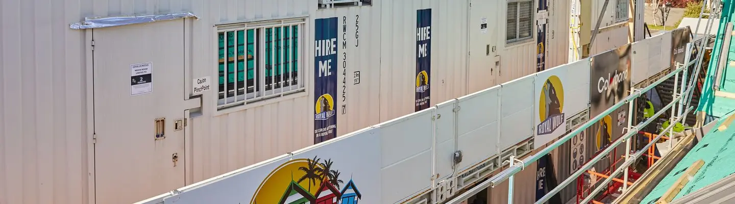 Modified storage containers as barriers on a film set, ensuring safety and site organisation