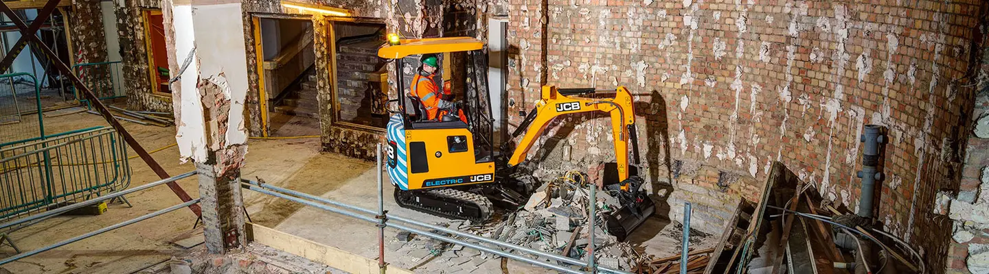 JCB mini excavator inside a building