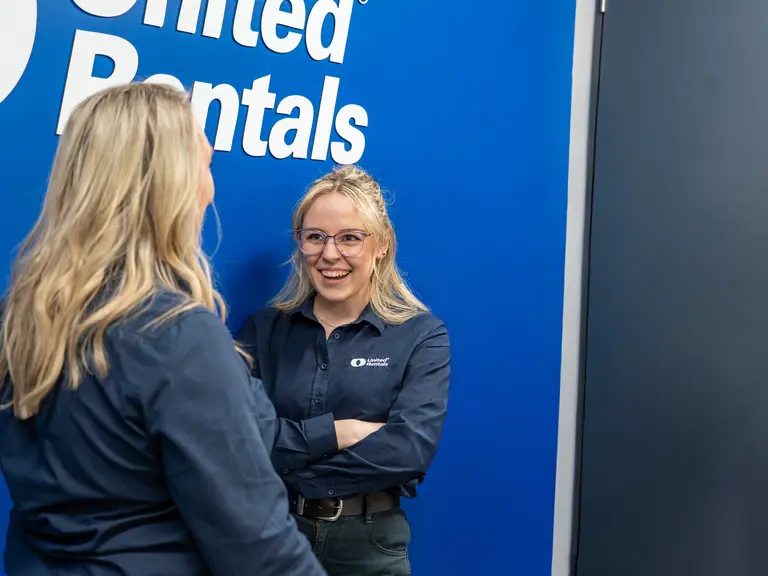 staff in office united rental back drop