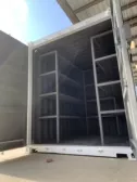 white shipping container with shelves on the inside and both doors open