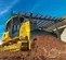 Yellow John Deere bulldozer with low ground pressure pushing dirt up an incline