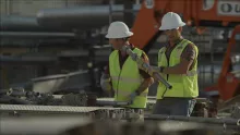 two men in hard hats on construction site