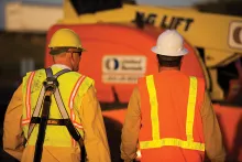 Two workers wearing personal protective equipment