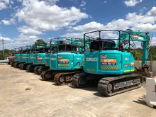 A variety of construction equipment neatly arranged on the ground outdoors, ready for use or demonstration.