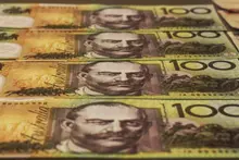 Stack of cash and coins symbolizing funding or investment in construction site safety and barrier installation projects.