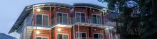 Modern container house featuring stacked shipping containers, large windows, and a minimalist architectural design.