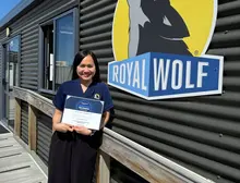 Sales representative receiving a Top Sales award certificate during a recognition ceremony.