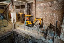JCB mini excavator inside a building