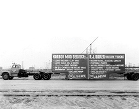 Old truck with Baker billboard.